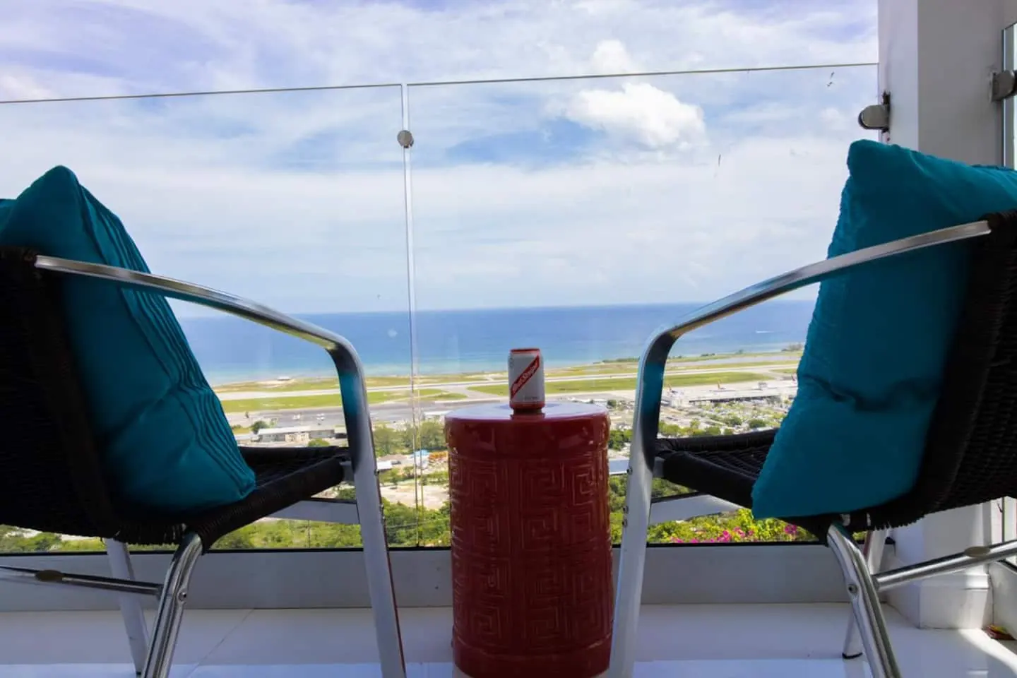 Bedroom 2 balcony seating with sea and airport runway views.