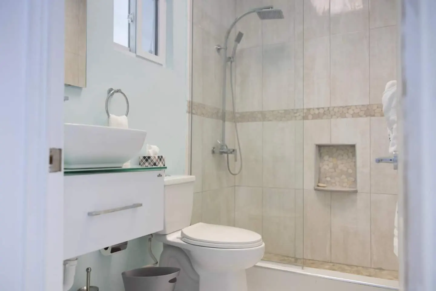 Bathroom 1 with shower enclosure, vessel basin and toilet.