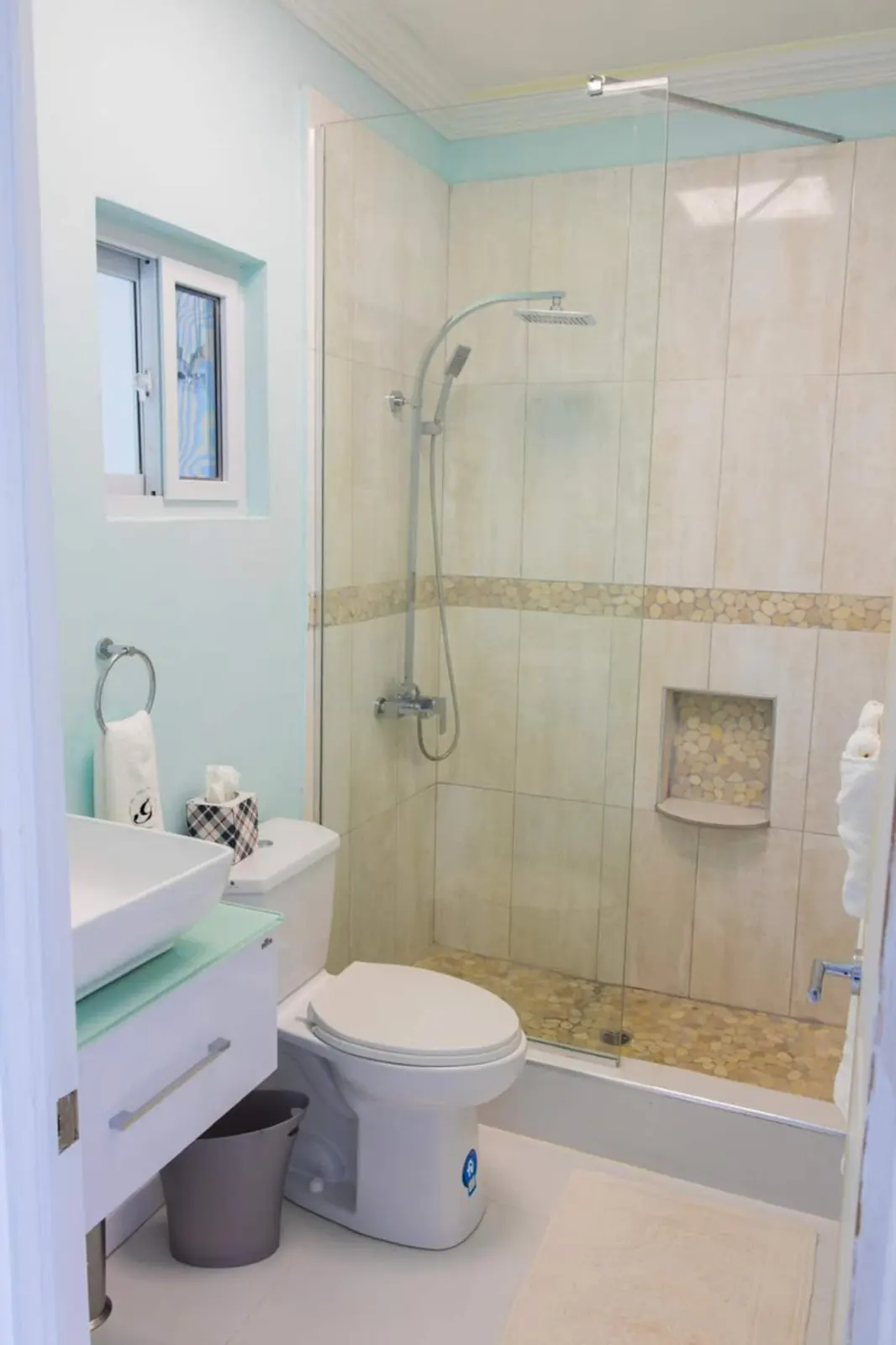 Bathroom 2 with glass shower enclosure, basin and toilet.