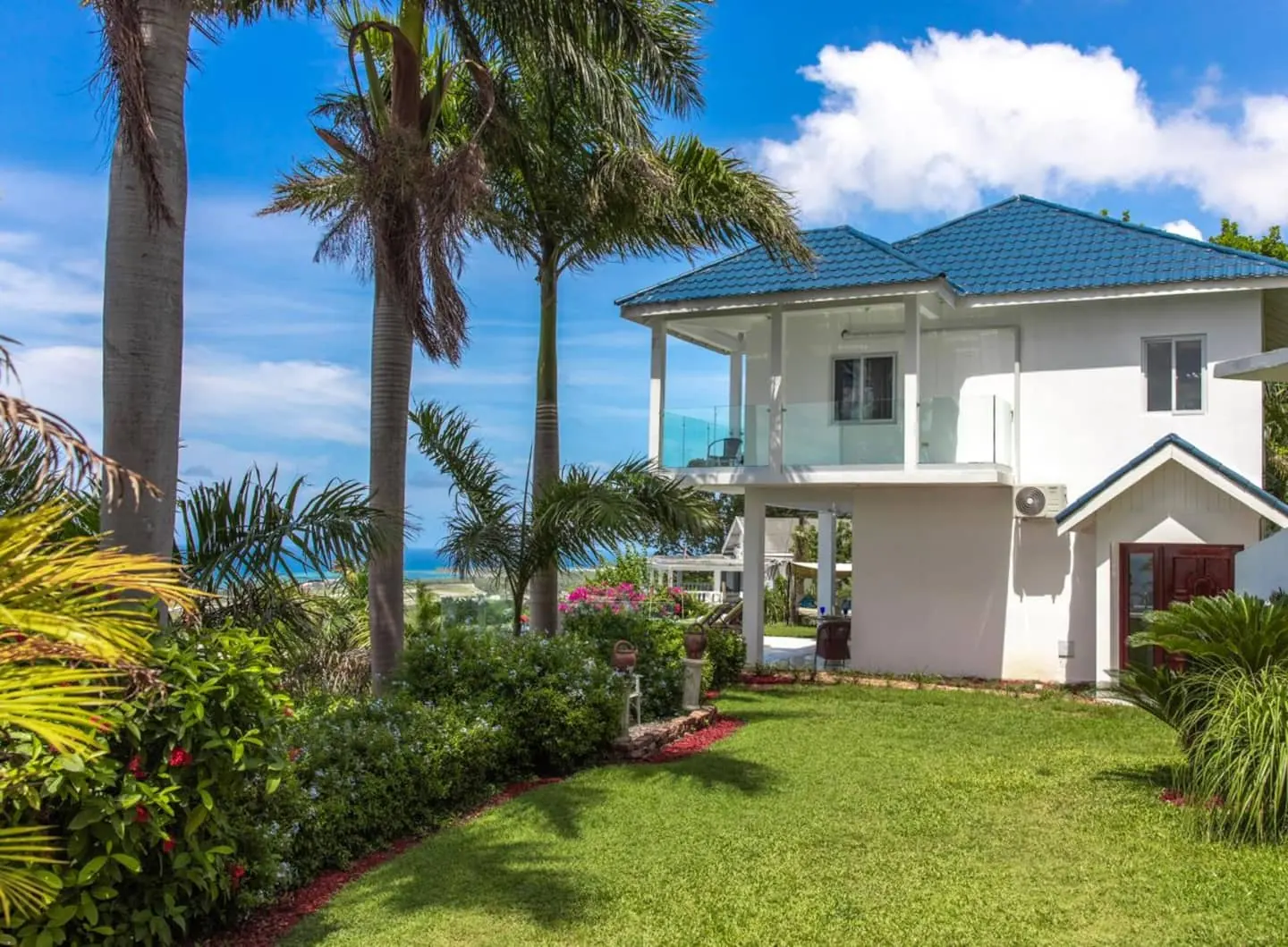 Glory’s lawn and tropical garden beside the house.