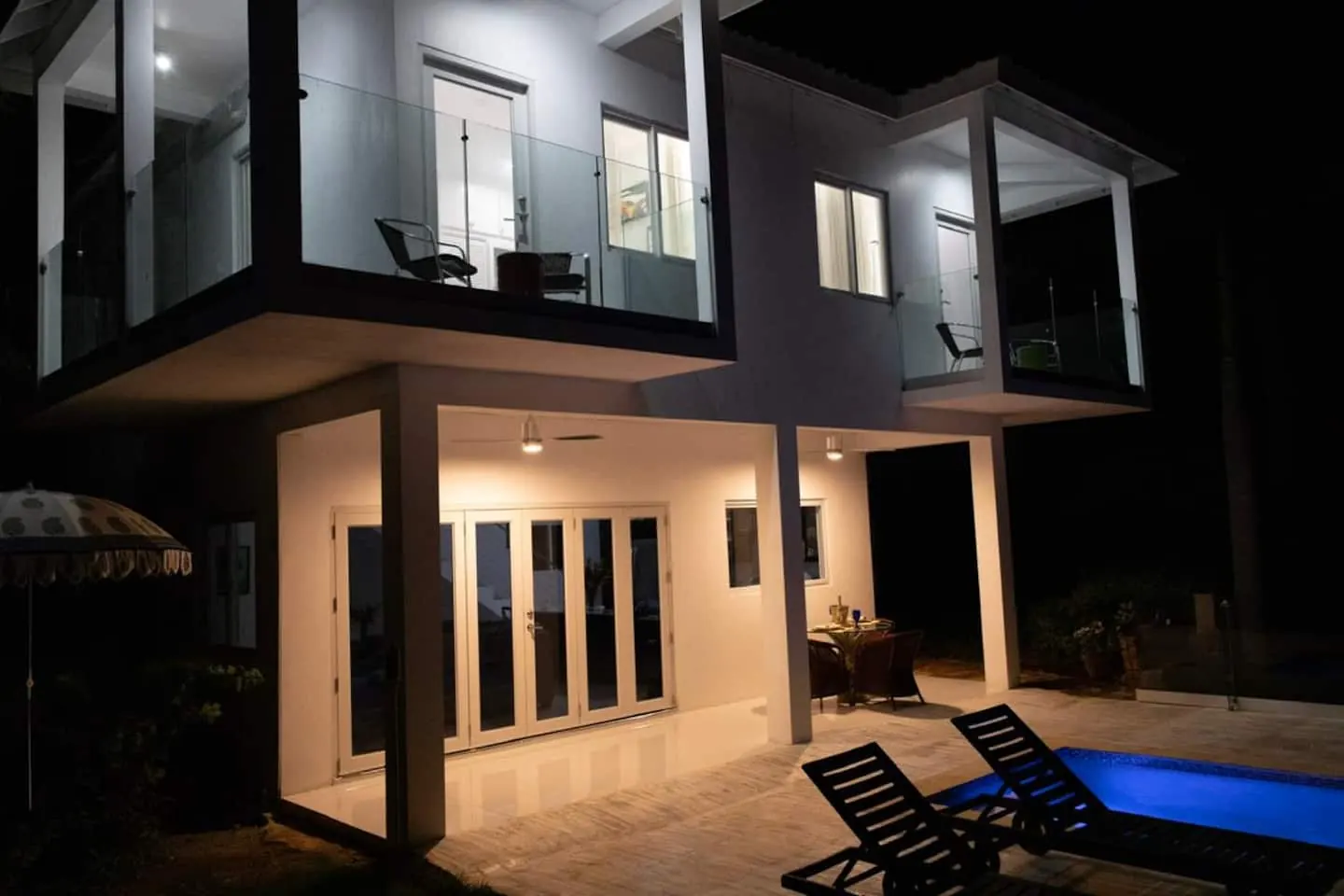 Glory’s balconies and covered pool terrace after dark.